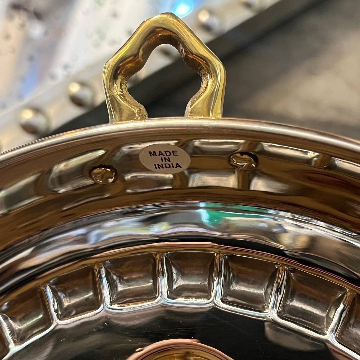 Shiny copper and chrome flower motif round pan with brass hook handle