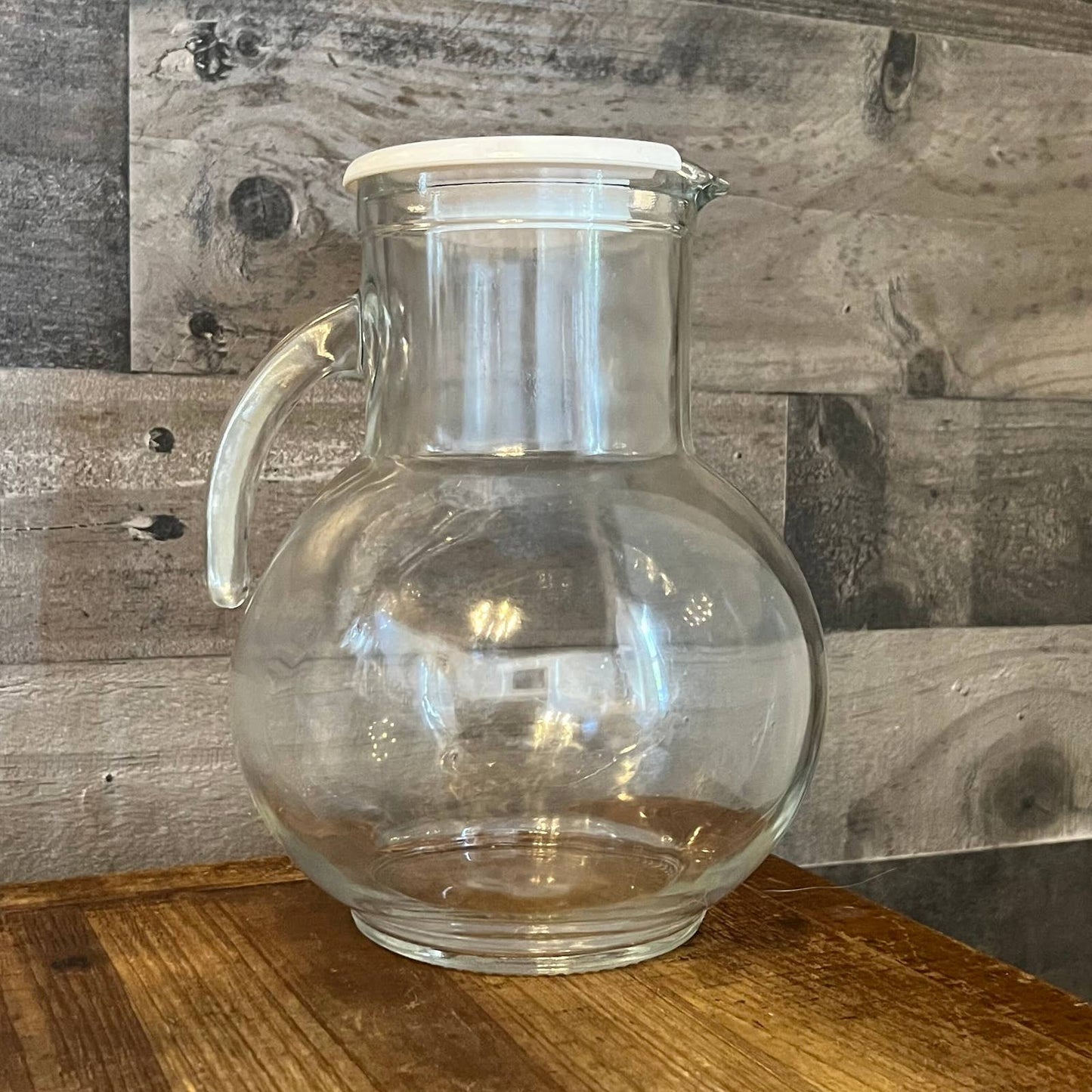 Vintage clear glass pitcher with white plastic lid