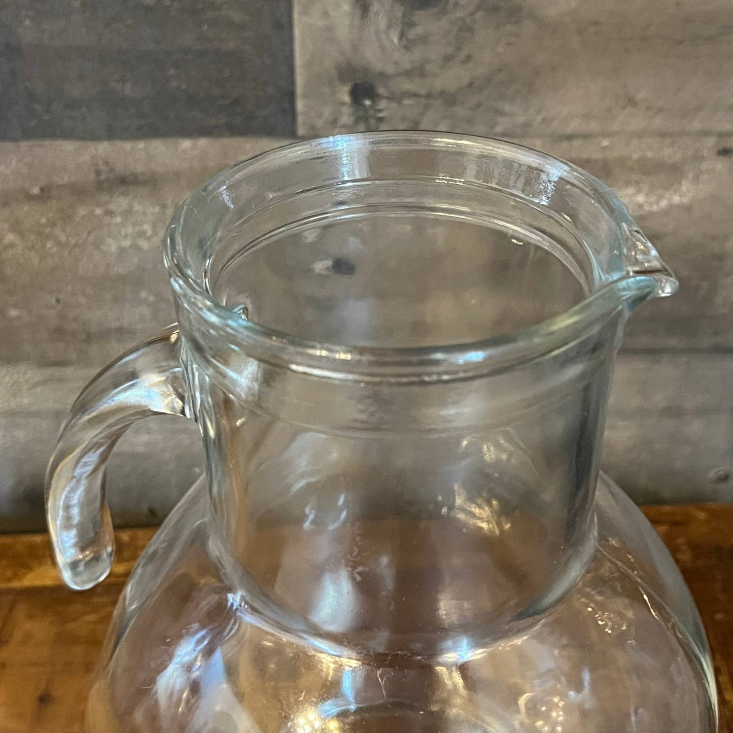 Vintage clear glass pitcher with white plastic lid