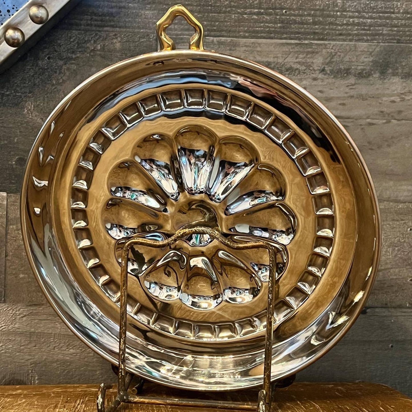 Shiny copper and chrome flower motif round pan with brass hook handle
