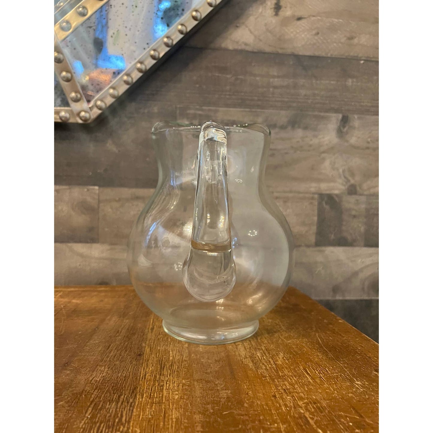 Clear glass bubbly handled beverage pitcher