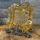 Vintage amber glass LG Wright daisy and button pattern ashtray