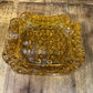 Vintage amber glass LG Wright daisy and button pattern ashtray