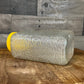 Anchor Hocking Soreno pattern clear glass refrigerator jar with yellow lid