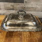 Ornate silver plated rounded rectangle serving dish with handled lid