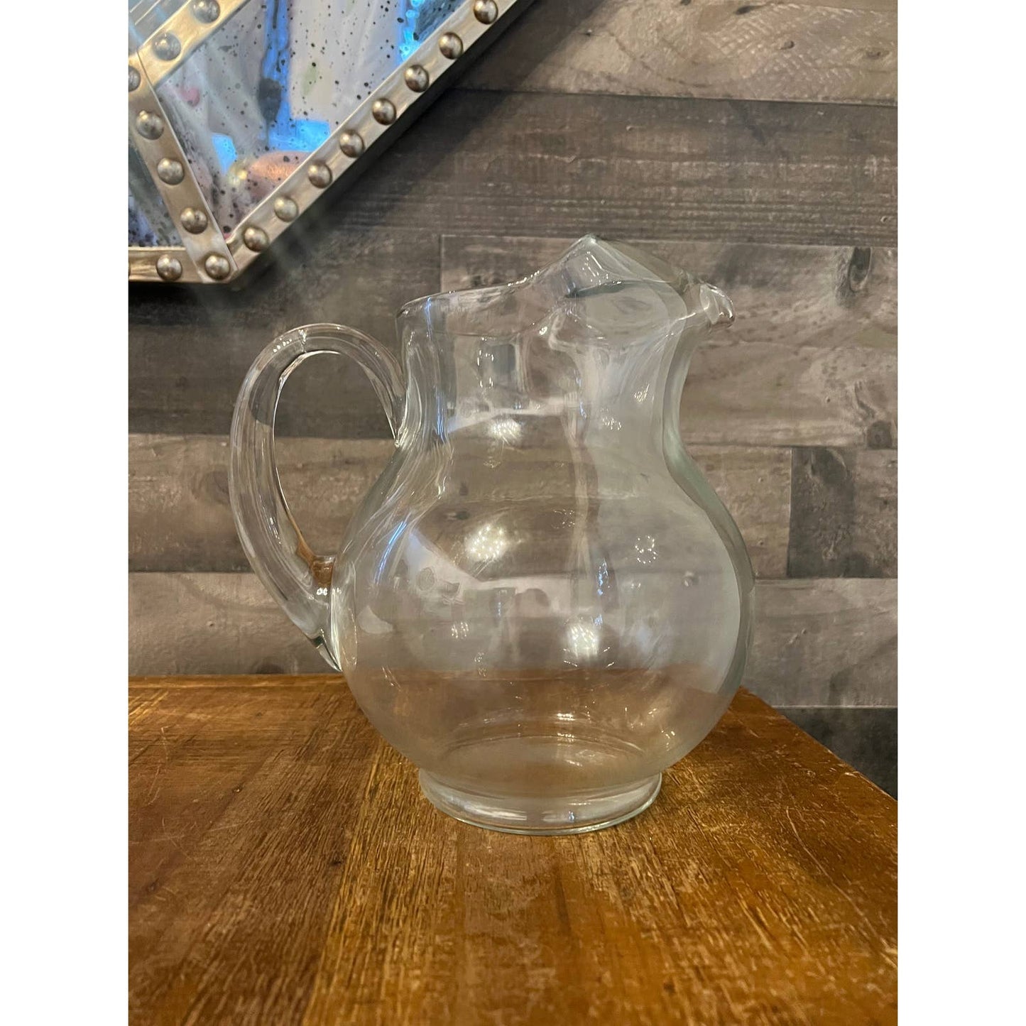 Clear glass bubbly handled beverage pitcher