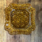 Vintage amber glass LG Wright daisy and button pattern ashtray