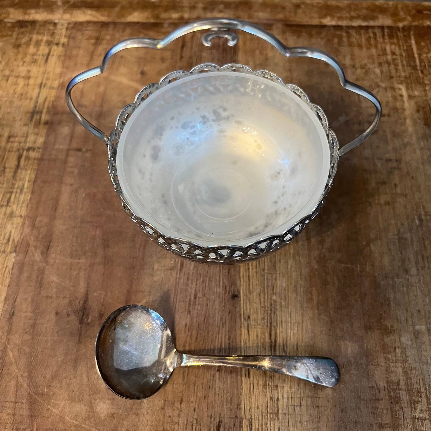 Vintage silver plated basket shaped footed sugar bowl with scalloped handle and spoon