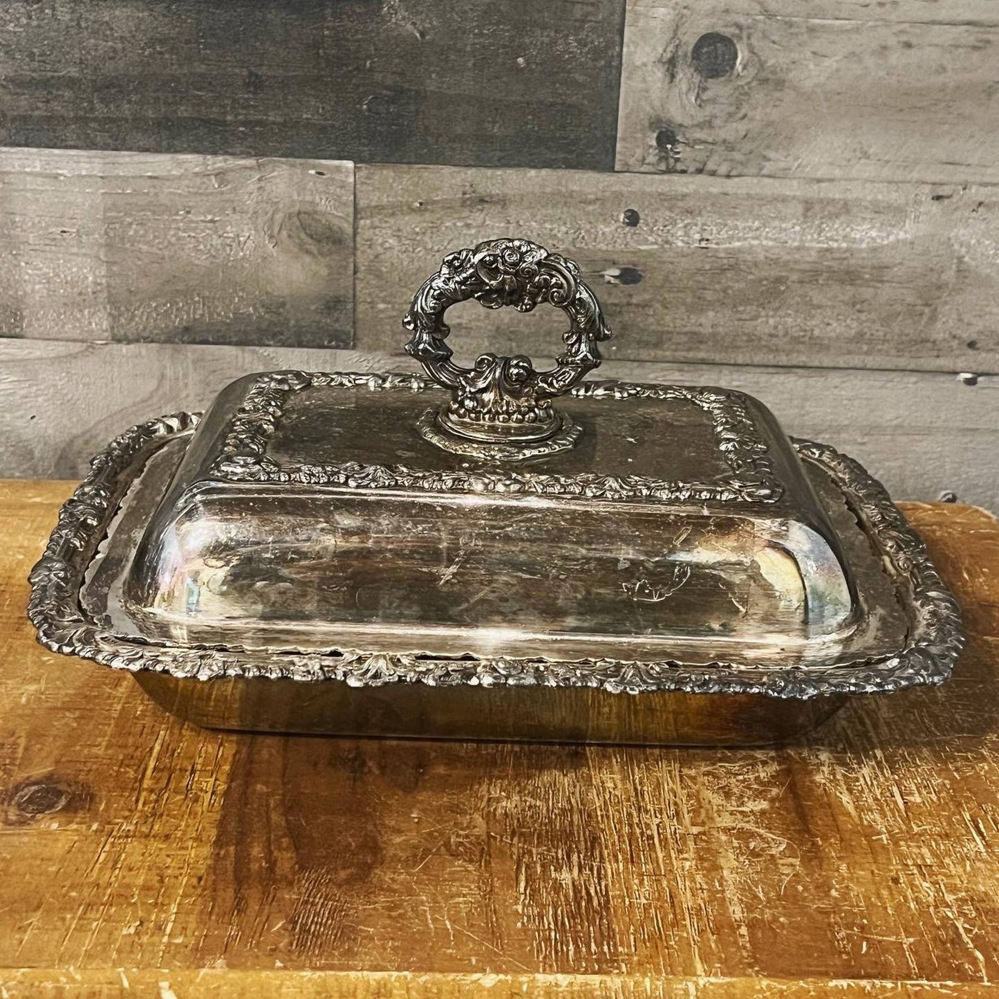 Ornate silver plated rounded rectangle serving dish with handled lid